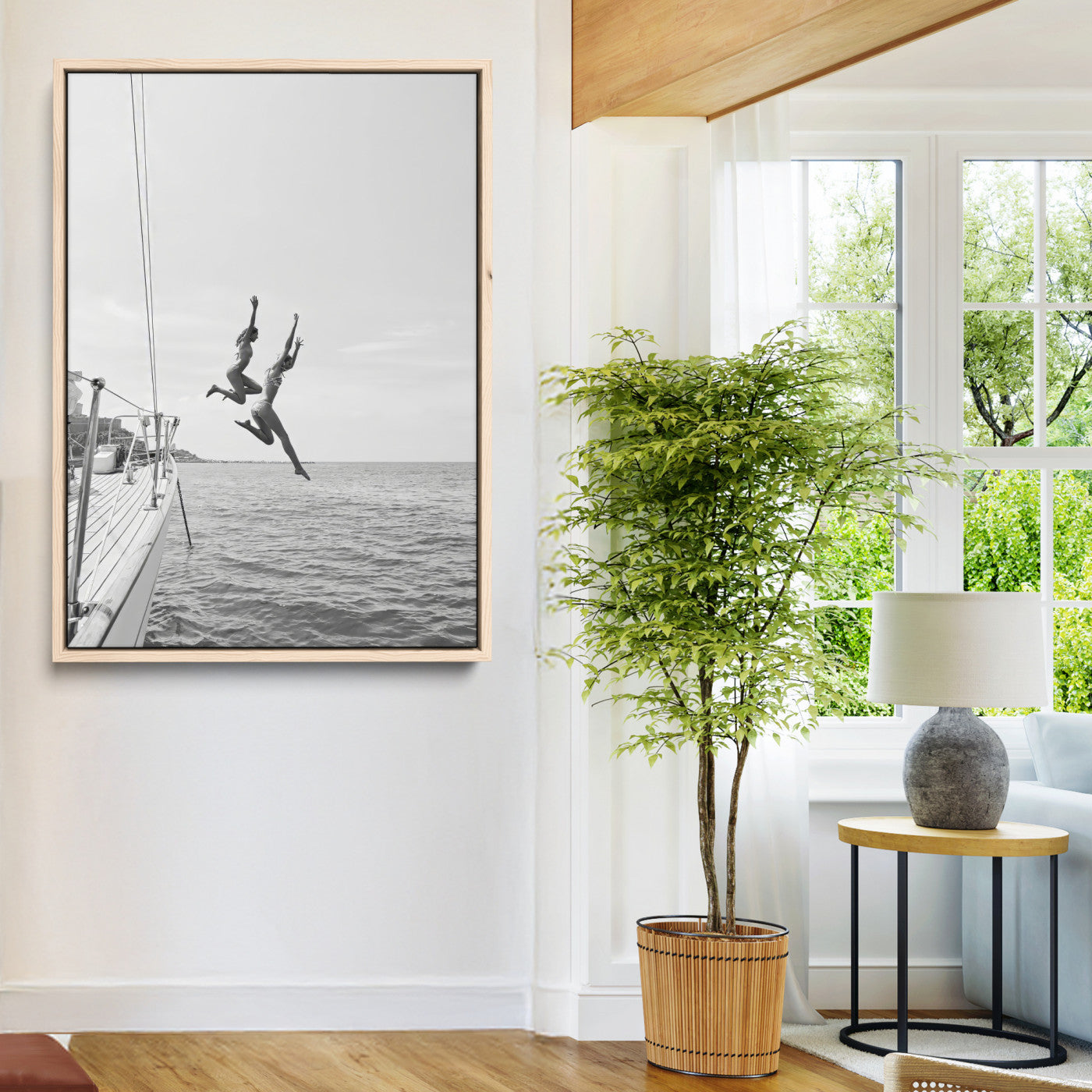 Black and white canvas wall art of two women joyfully jumping off a yacht into the sea, ideal for minimalist coastal or nautical-themed spaces.