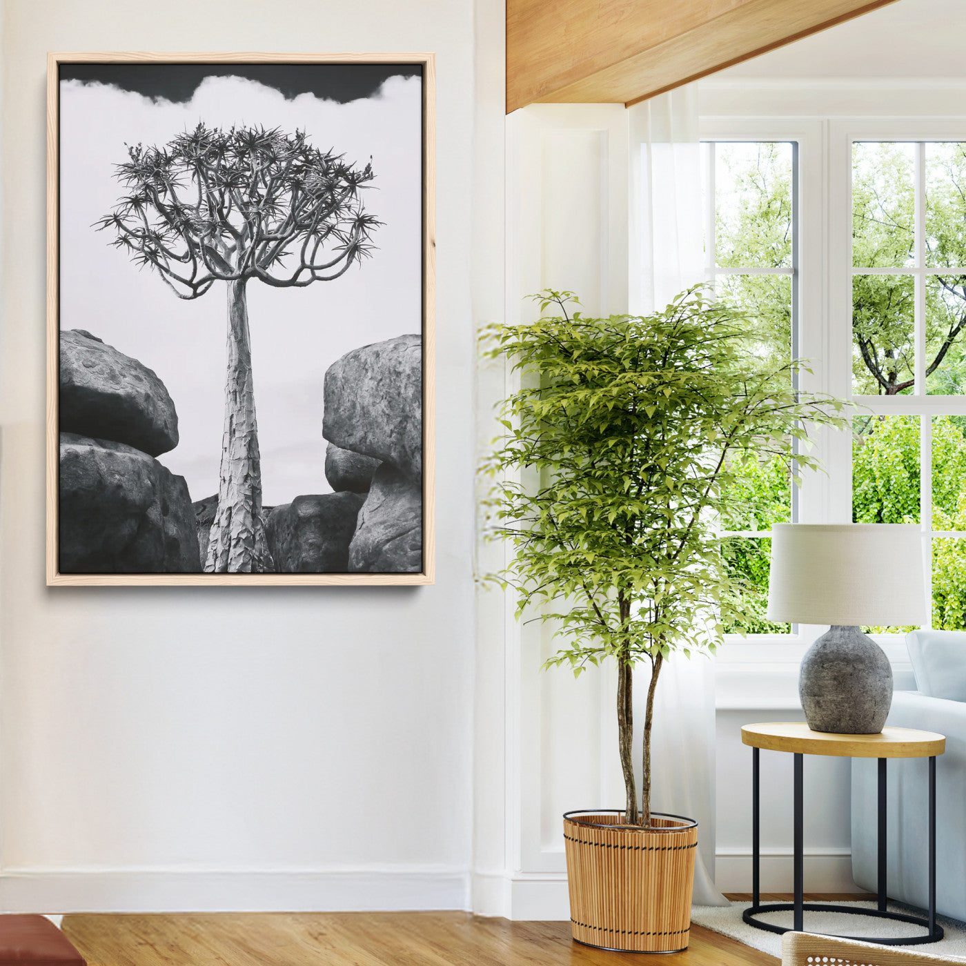 Tall desert tree in black and white, standing between large rocks, perfect for bold and minimalist nature-themed interior spaces.