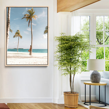 Person leaning on a palm tree at a tropical beach with white sand and turquoise water, perfect for coastal or beach-themed home decor.