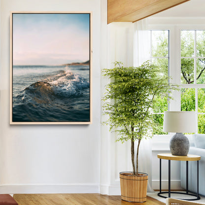 Close-up of ocean waves rolling gently toward the shore at sunset, creating a peaceful and minimalist coastal scene.