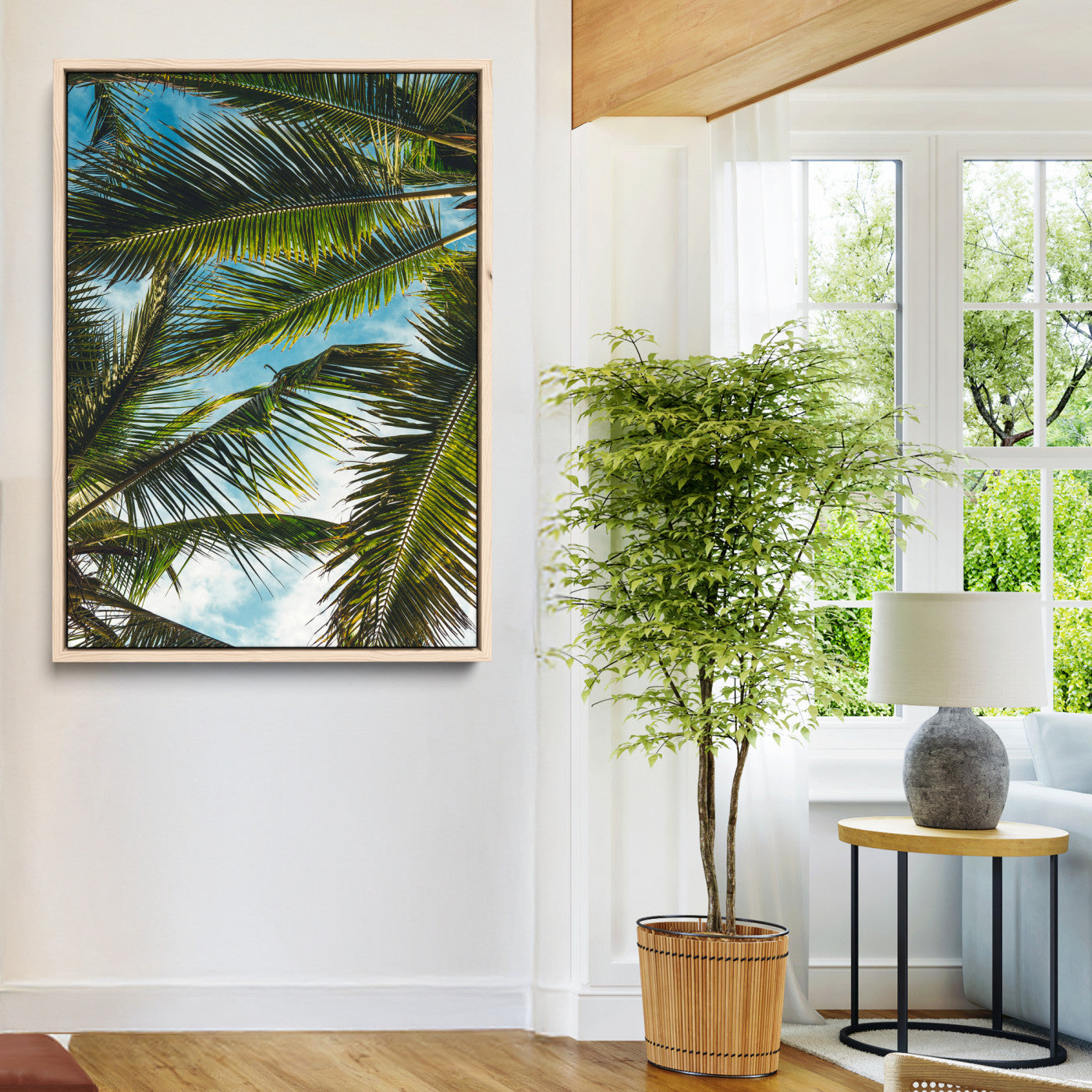 Looking up at lush green palm leaves against a bright blue sky, creating a tropical and relaxing coastal aesthetic.