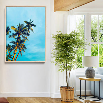 "Tall palm trees with golden sunlight against a vibrant blue sky, creating a tropical, relaxing atmosphere for coastal and beach-themed decor.
