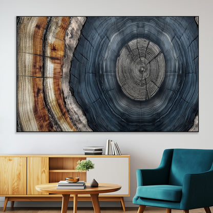 A stunning close-up of a tree trunk showing the intricate, circular growth rings, showcasing the natural textures and rich contrasts in deep blues, browns, and silvers.
