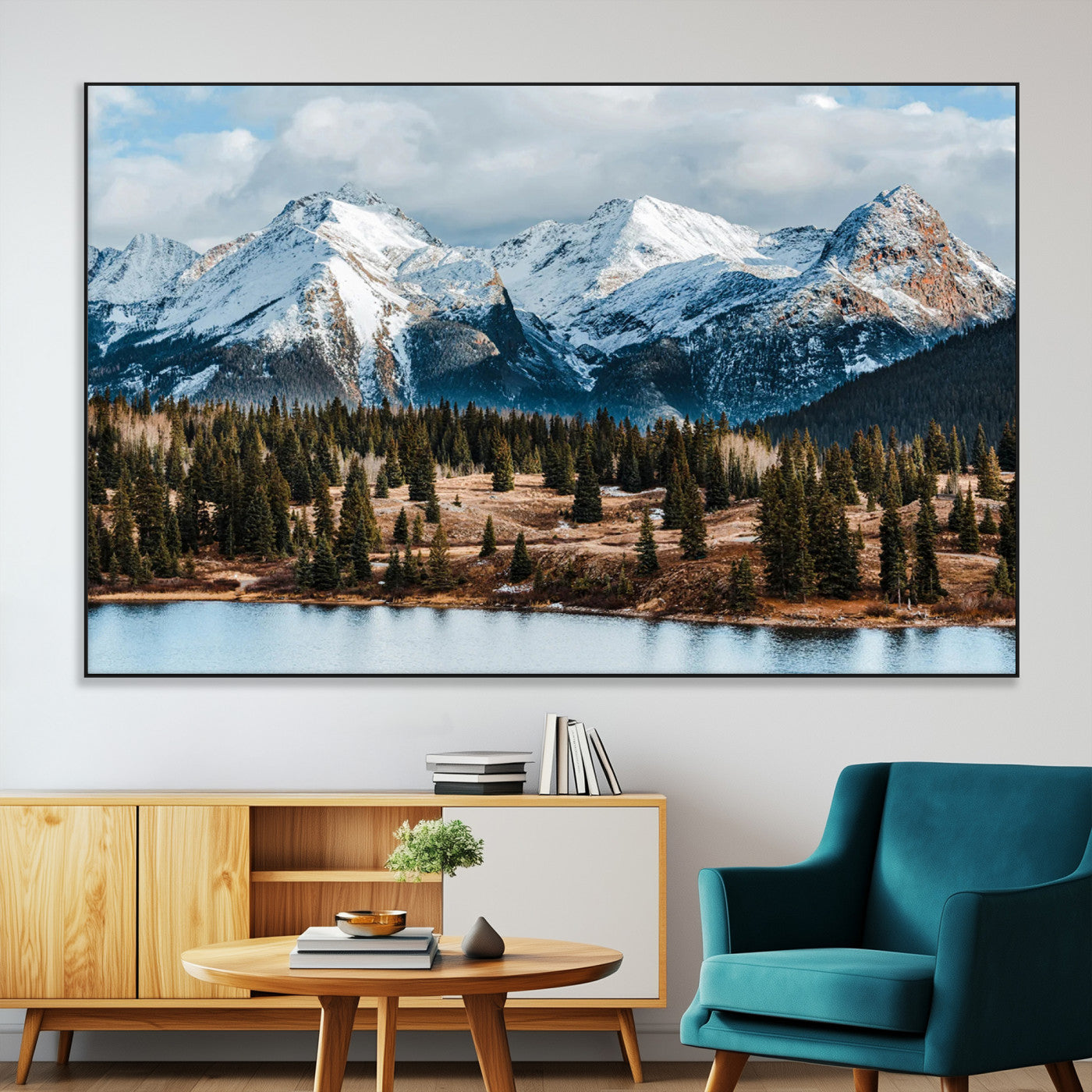 Framed canvas of snowy mountain peaks with pine forest and alpine lake, perfect for winter cabin or wilderness-inspired home decor.