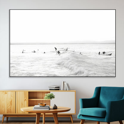 Monochrome photo of surfers riding and waiting on ocean waves, ideal for surf-themed or coastal energy wall decor.