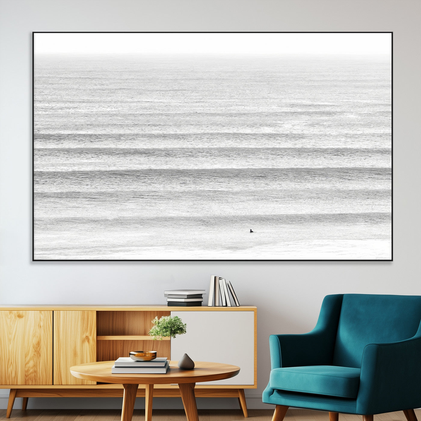 Monochrome photo of a lone surfer in calm layered waves, perfect for minimalist coastal or moody ocean-inspired wall decoration.