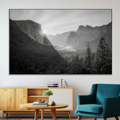 Black and white landscape of Yosemite with sun rays peeking over El Capitan, ideal for moody nature or modern rustic decor.