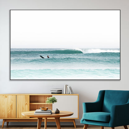 Minimalist photo of a lone surfer on calm aqua waves under bright sky, perfect for Scandinavian coastal or serene ocean-inspired home decor.