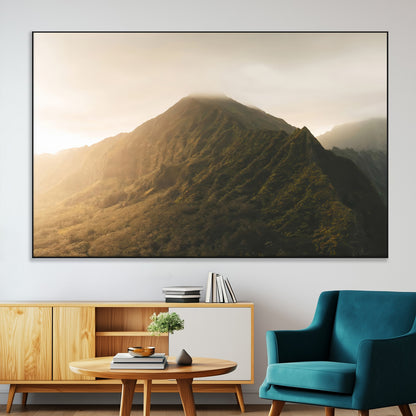 Sunlit mountain peak with mist rolling over its rugged slopes, bathed in golden light, creating a warm and tranquil nature-inspired scene.