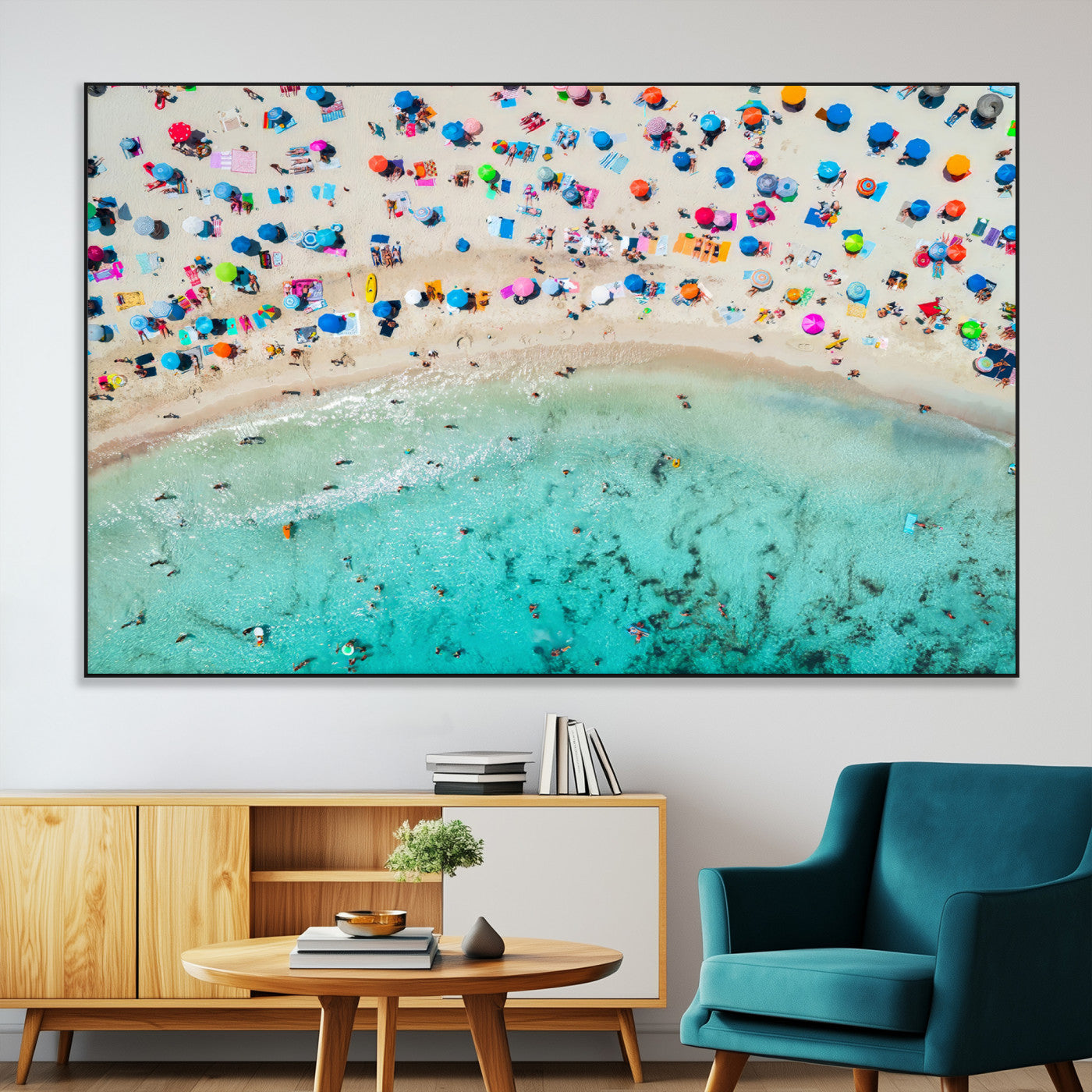 Aerial view of a vibrant beach filled with colorful umbrellas and people enjoying the turquoise ocean, capturing a lively summer vacation scene.
