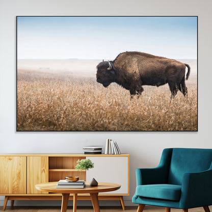 A majestic bison standing in an open prairie field, its strong form blending into the golden grass under a vast blue sky, evoking the wild spirit of the American plains.
