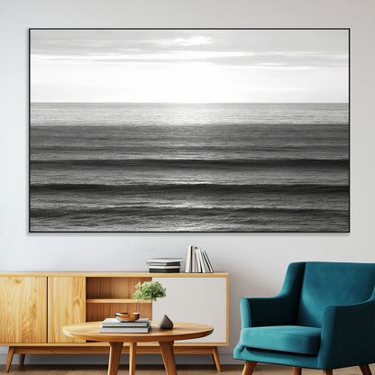 Minimalist black and white ocean view with layered waves reflecting sunlight, evoking a sense of calm and coastal serenity.