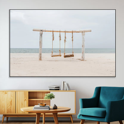 A rustic wooden beach swing stands on a serene sandy shore with an ocean horizon in the background, creating a tranquil and dreamy coastal escape.