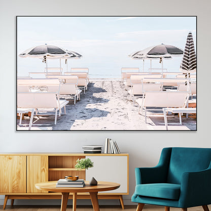 A serene minimalist beach scene featuring striped umbrellas, soft pastel sand, and an elegant lounge setup, creating a tranquil and stylish coastal retreat.