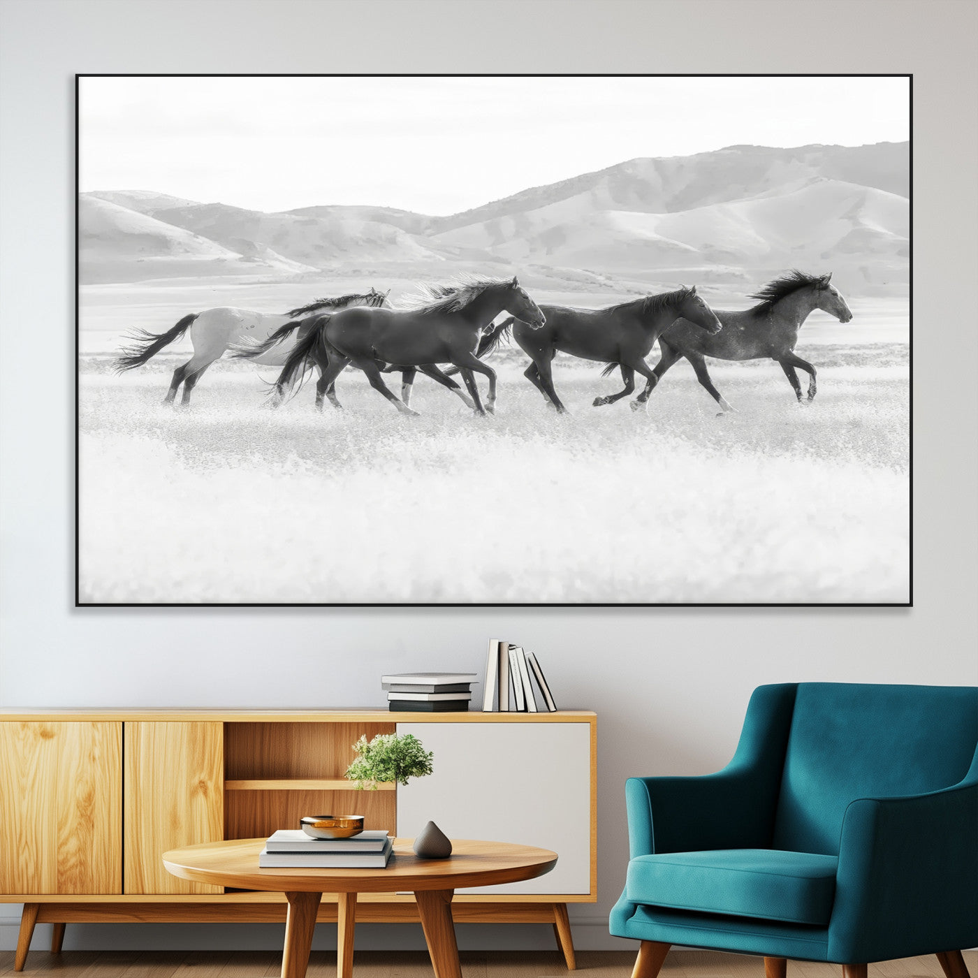 A black and white image of wild horses running freely across an open grassland, capturing the power and beauty of untamed nature in a rustic western setting.