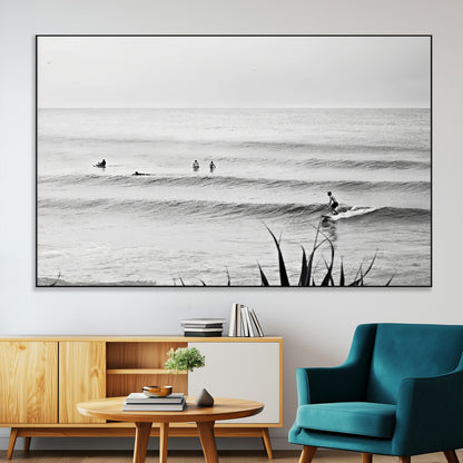 Monochrome canvas of surfers on calm ocean waves, ideal for minimalist coastal or beach-inspired interior decor.