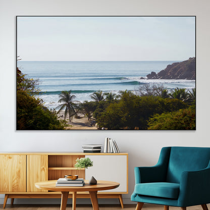 View of calm ocean waves with palm trees and a tropical coastline, ideal for coastal boho or beach-themed wall decor.