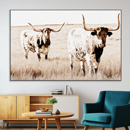 Two Texas longhorn cows standing in a sepia-toned pasture, evoking rustic charm perfect for farmhouse or western country interiors. (