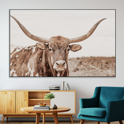 A longhorn cow in soft beige desert tones, standing calmly in open land, perfect for neutral western or rustic farmhouse interiors.