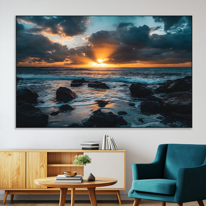 An awe-inspiring sunset over the ocean with rays of light piercing through dramatic clouds, creating a beautiful seascape with rocks in the foreground.