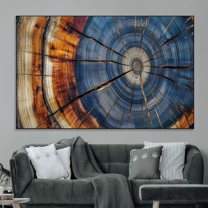 A stunning close-up view of a tree trunk, showcasing the intricate growth rings in a vibrant mix of warm browns, cool blues, and hints of natural texture.
