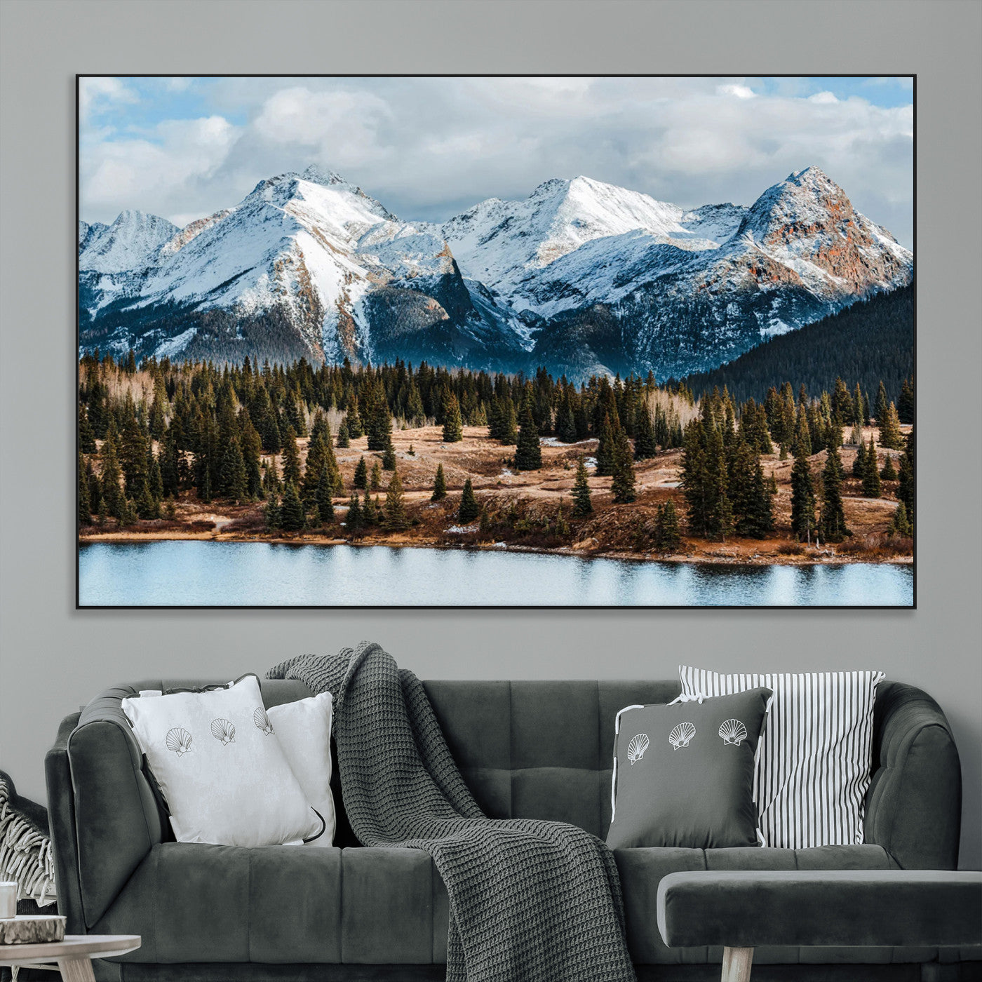 Framed canvas of snowy mountain peaks with pine forest and alpine lake, perfect for winter cabin or wilderness-inspired home decor.