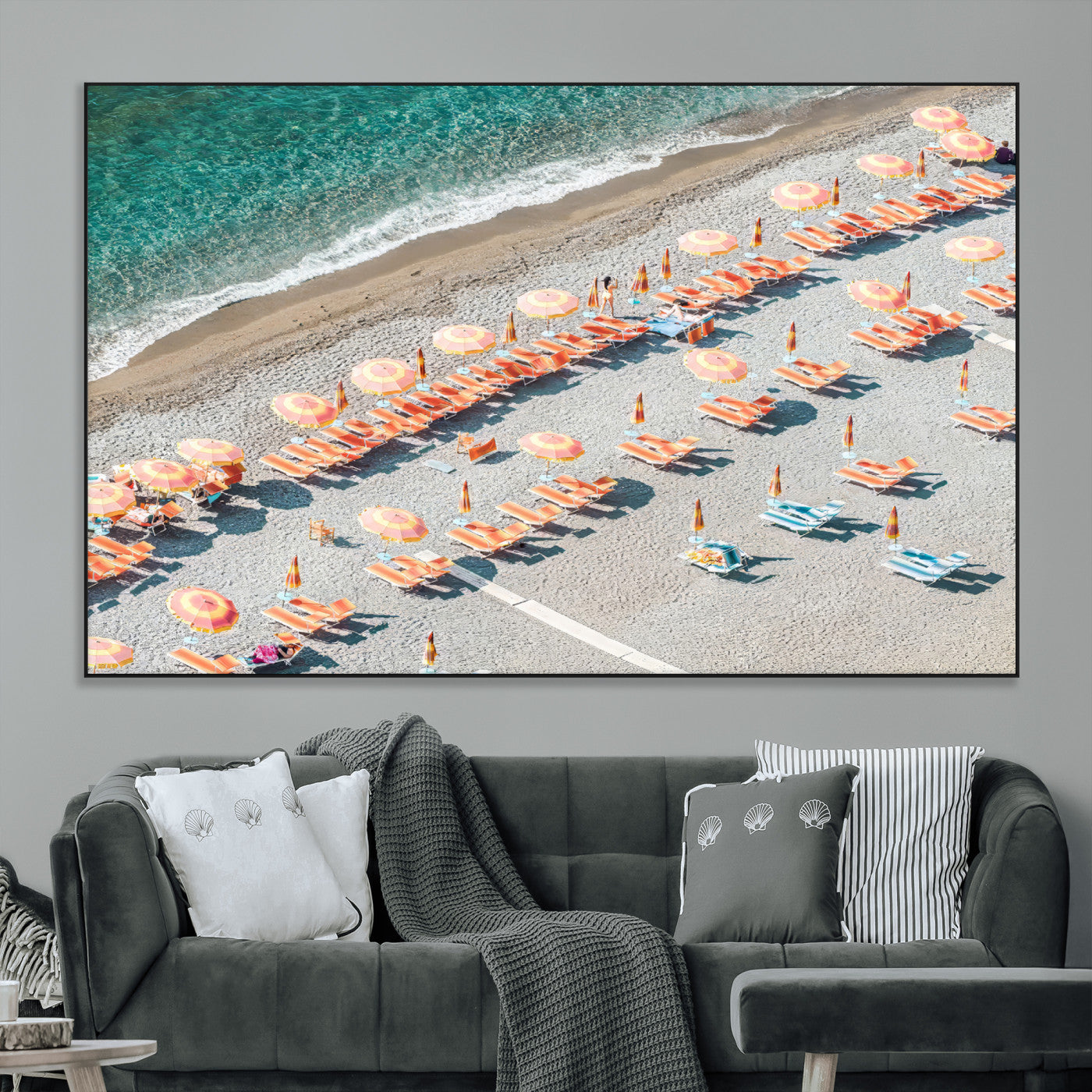 Framed canvas of colorful umbrellas and chairs on a Mediterranean beach, perfect for retro coastal or summer-themed home decor.