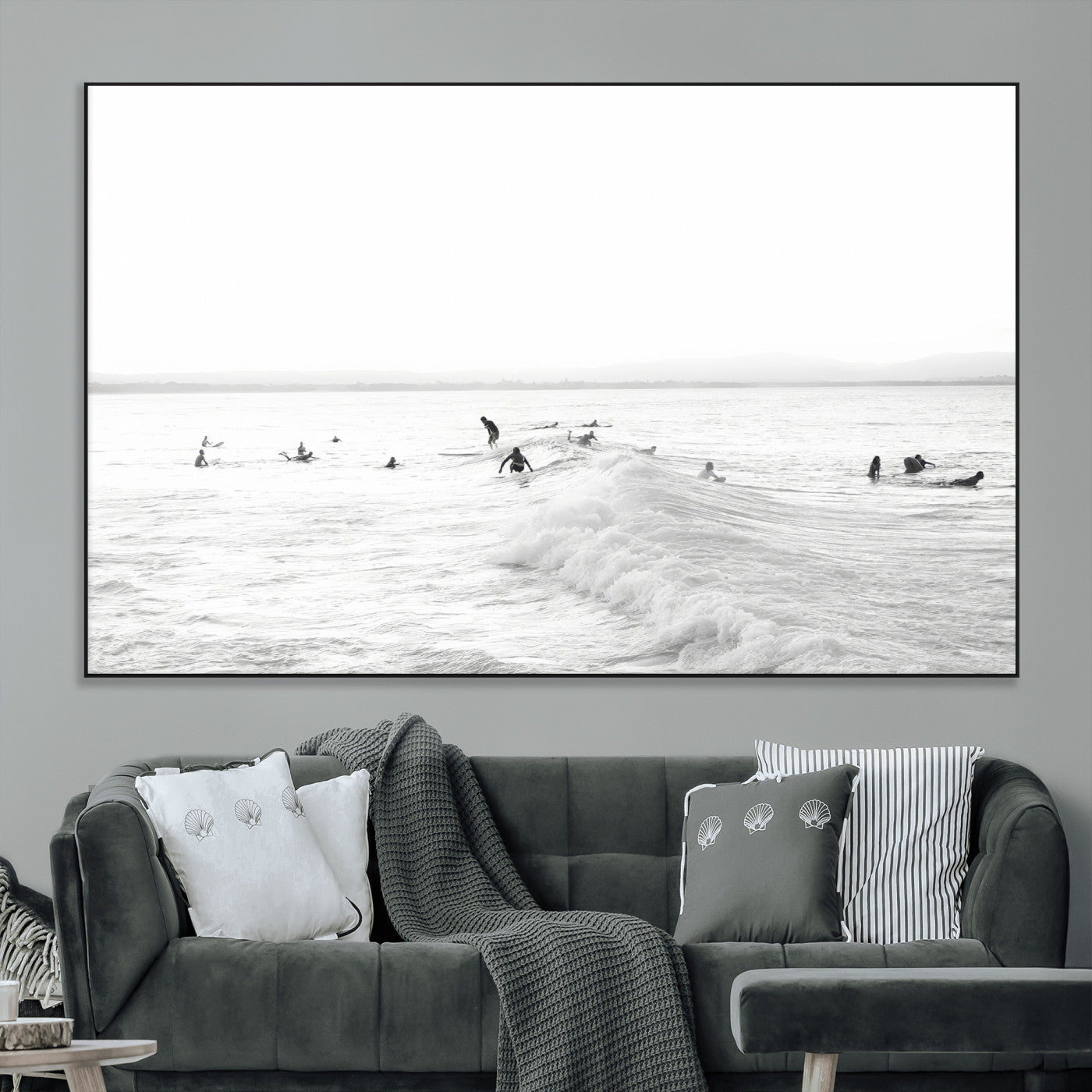 Monochrome photo of surfers riding and waiting on ocean waves, ideal for surf-themed or coastal energy wall decor.
