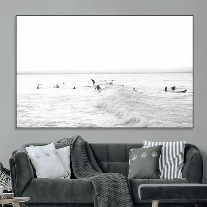 Monochrome photo of surfers riding and waiting on ocean waves, ideal for surf-themed or coastal energy wall decor.