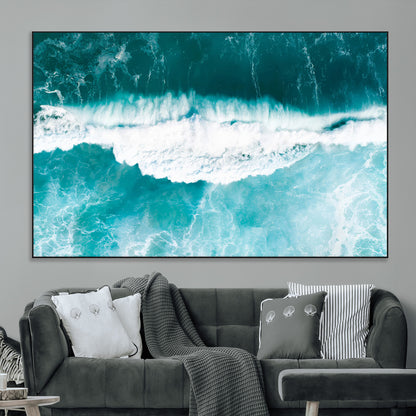 Aerial view of turquoise ocean waves crashing with white foam, perfect for tropical coastal or modern beach-style home decor.