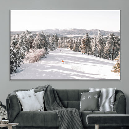 Bright ski trail lined with snow-covered pines and a skier in orange, perfect for alpine adventure or winter sports-inspired decor.