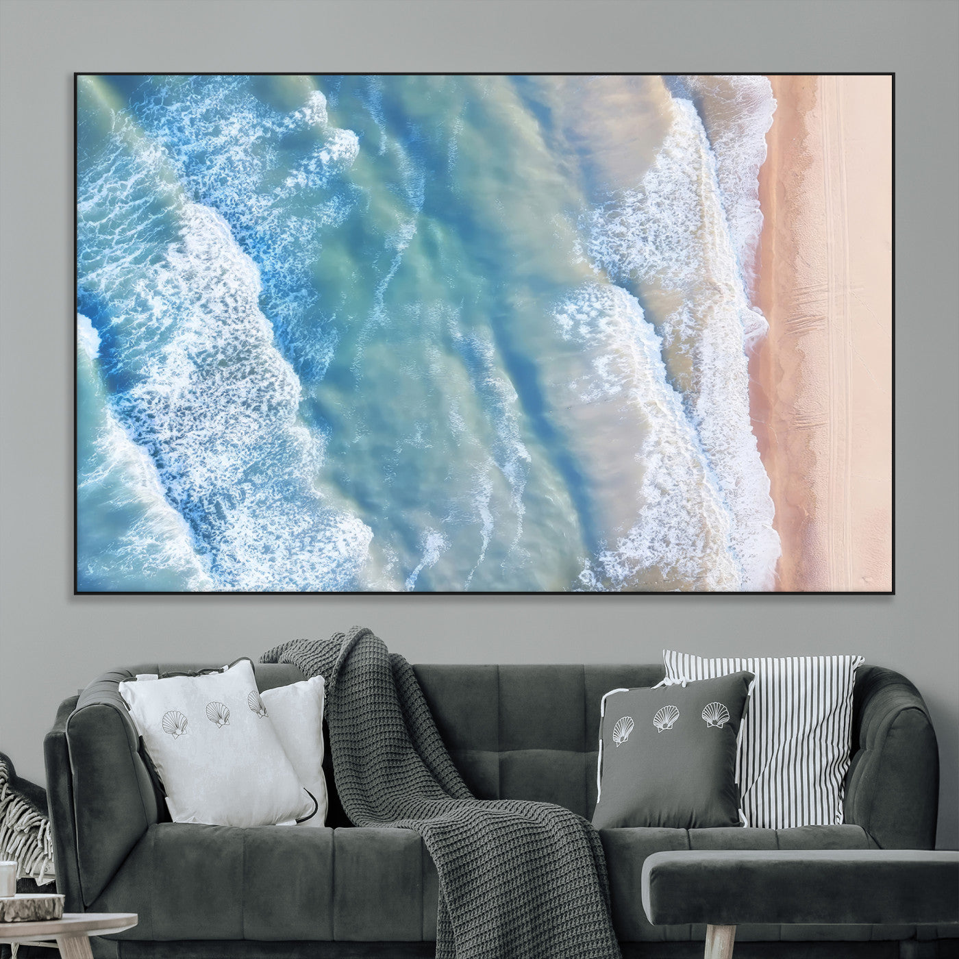 Aerial photo of soft blue waves meeting sandy shore, perfect for modern coastal or beach-themed decor with a light and tranquil aesthetic.