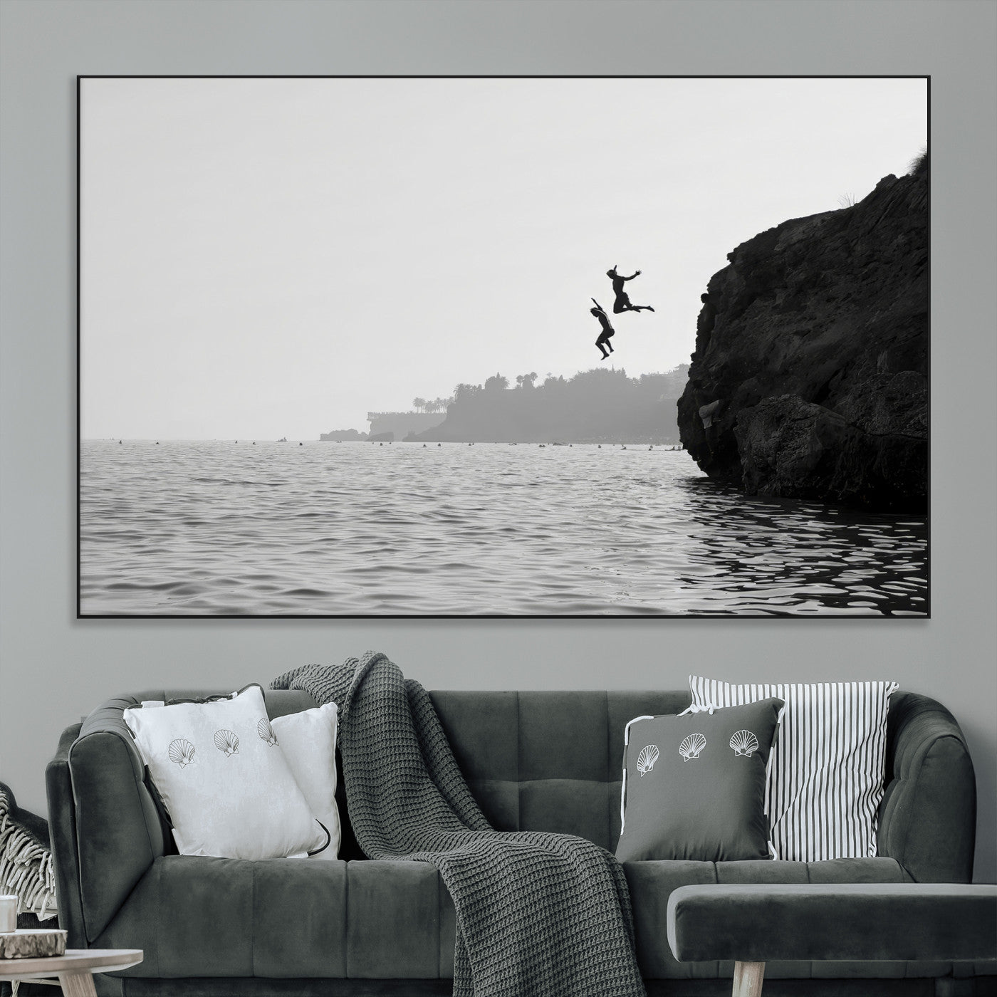 Black and white canvas of two figures cliff jumping into the sea, captured with moody tones, ideal for modern coastal or adventure-themed home decor.   2/2