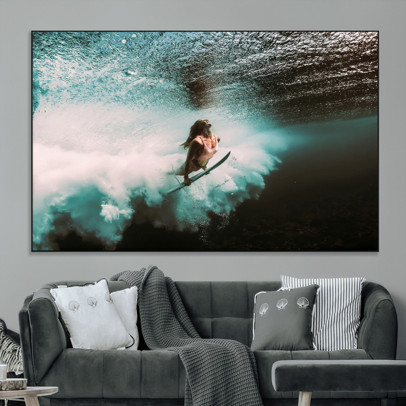 Vibrant underwater photo of a female surfer diving through turquoise waves, perfect for coastal boho or surf-inspired home decor.