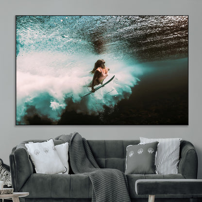Vibrant underwater photo of a female surfer diving through turquoise waves, perfect for coastal boho or surf-inspired home decor.