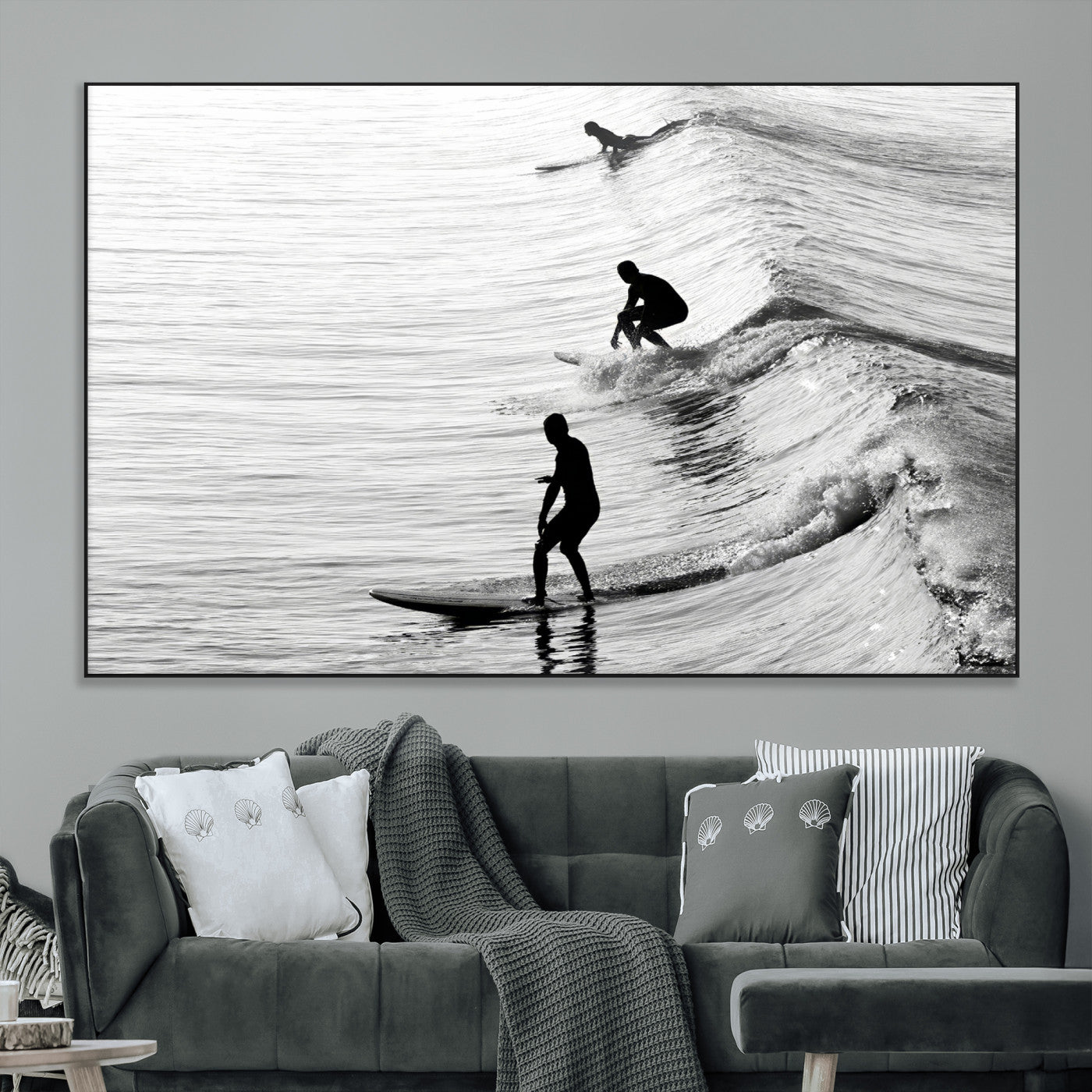 Black and white photo of surfers riding waves in a moody, high-contrast scene, ideal for modern coastal or surf-inspired home decor.