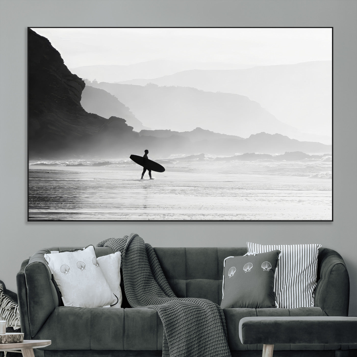 A lone surfer walking along a misty beach with cliffs in the background, carrying their board, capturing a serene and minimal ocean moment.