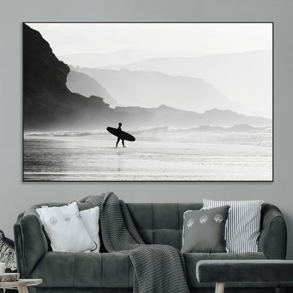 A lone surfer walking along a misty beach with cliffs in the background, carrying their board, capturing a serene and minimal ocean moment.