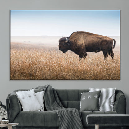 A majestic bison standing in an open prairie field, its strong form blending into the golden grass under a vast blue sky, evoking the wild spirit of the American plains.