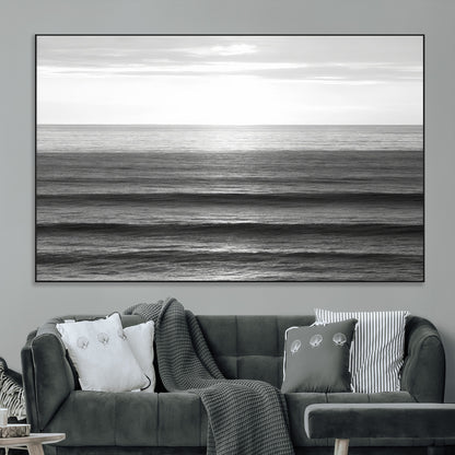Minimalist black and white ocean view with layered waves reflecting sunlight, evoking a sense of calm and coastal serenity.