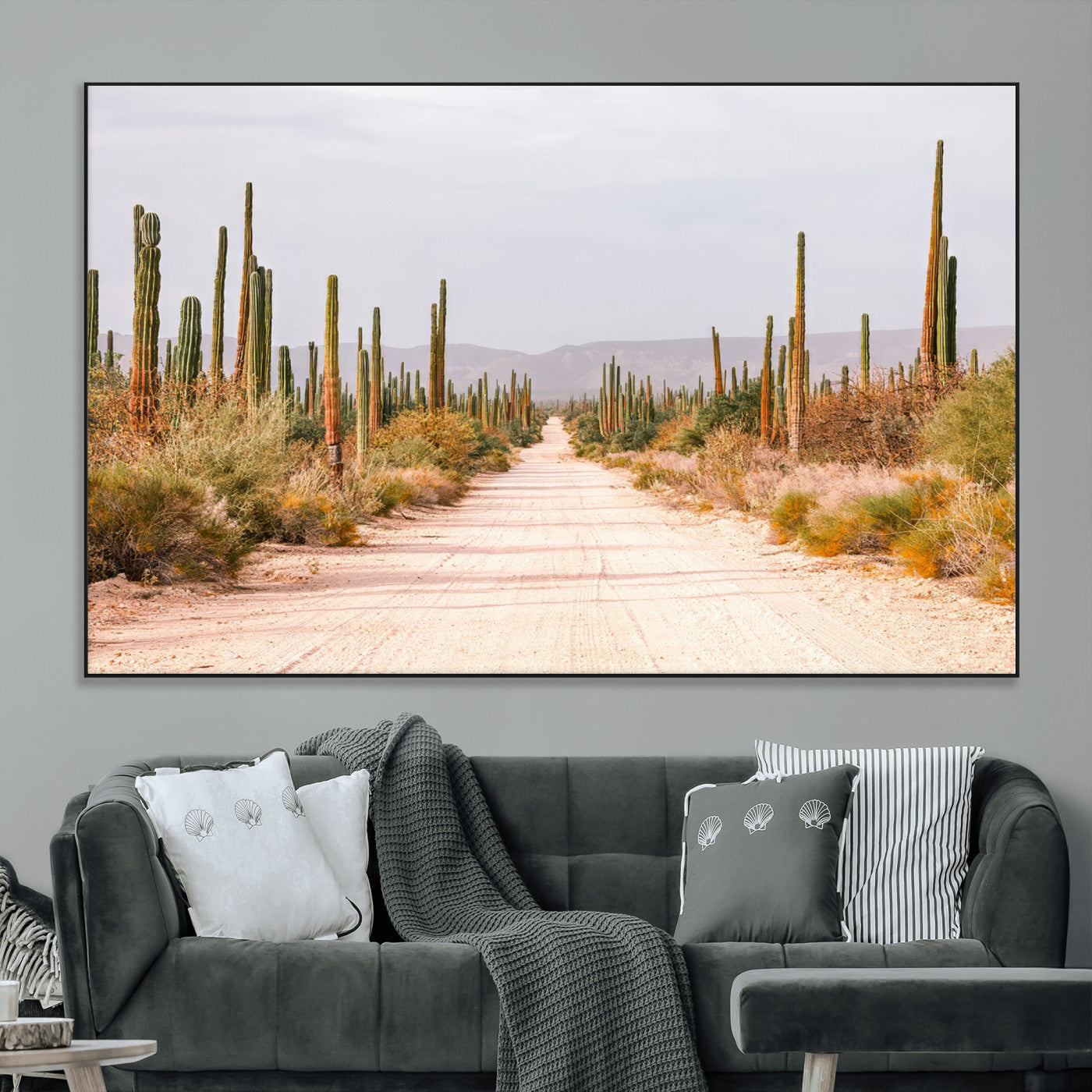 A desert road lined with saguaro cacti under a golden sky, creating a warm southwestern feel, perfect for boho or rustic decor.