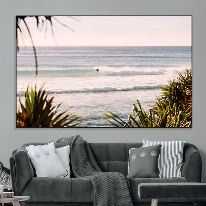 Canvas of a lone surfer riding a pastel wave at sunrise, perfect for tropical or coastal-themed spaces with a relaxed, airy vibe.