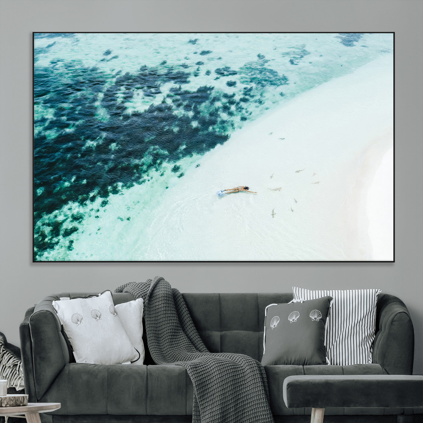 Canvas featuring an aerial view of a swimmer in shallow turquoise waters with coral patterns, ideal for tropical coastal home decor.
