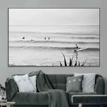 Monochrome canvas of surfers on calm ocean waves, ideal for minimalist coastal or beach-inspired interior decor.