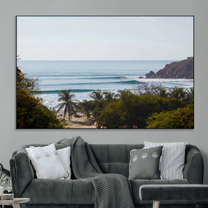 View of calm ocean waves with palm trees and a tropical coastline, ideal for coastal boho or beach-themed wall decor.