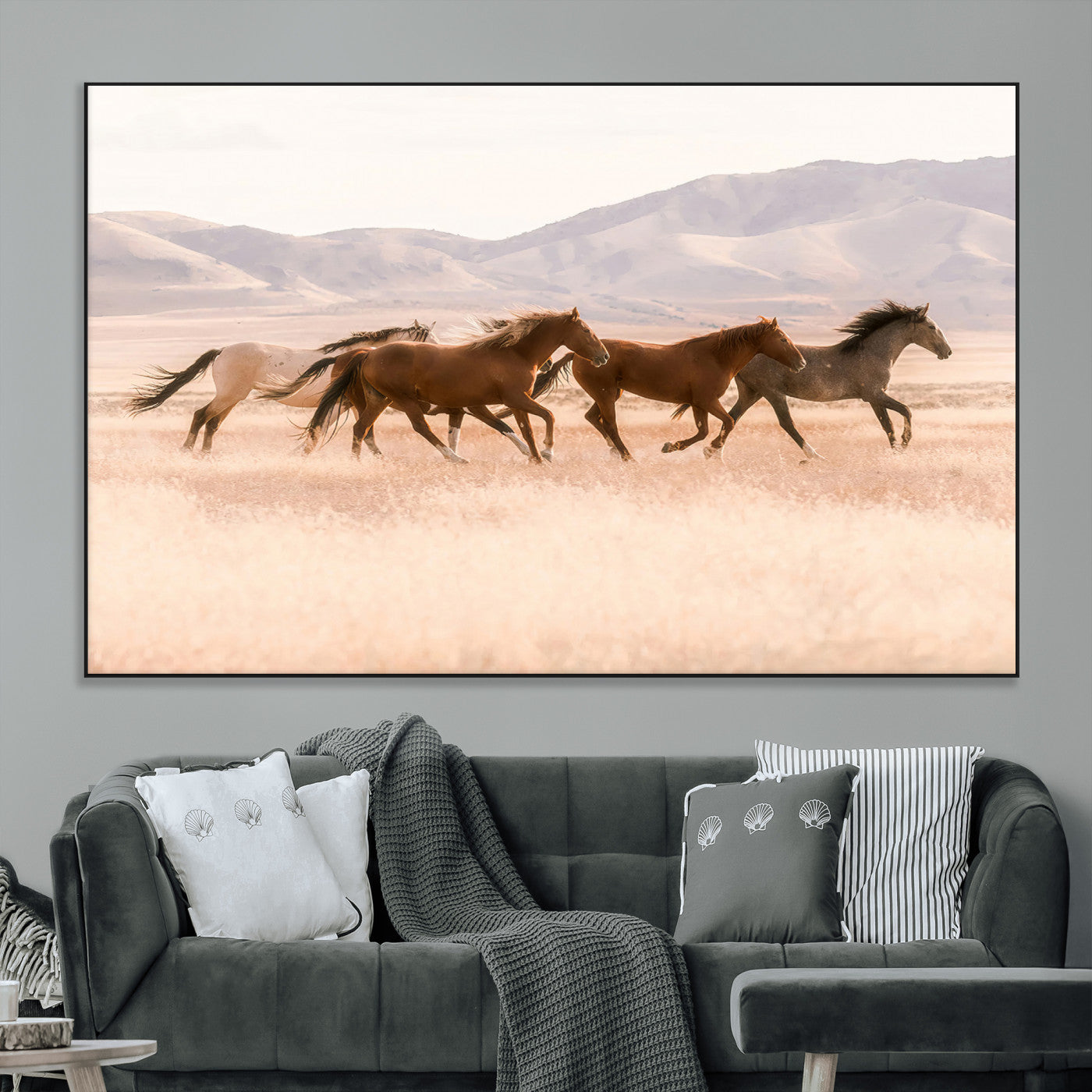 A herd of wild horses galloping through a sunlit desert plain with mountains in the background, perfect for rustic or western-themed wall decor.