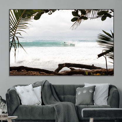 Tropical beach view with palm trees and surfer riding a wave, perfect for boho or coastal-inspired interior wall decor.