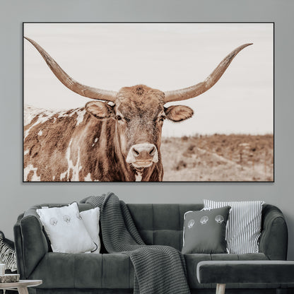 A longhorn cow in soft beige desert tones, standing calmly in open land, perfect for neutral western or rustic farmhouse interiors.