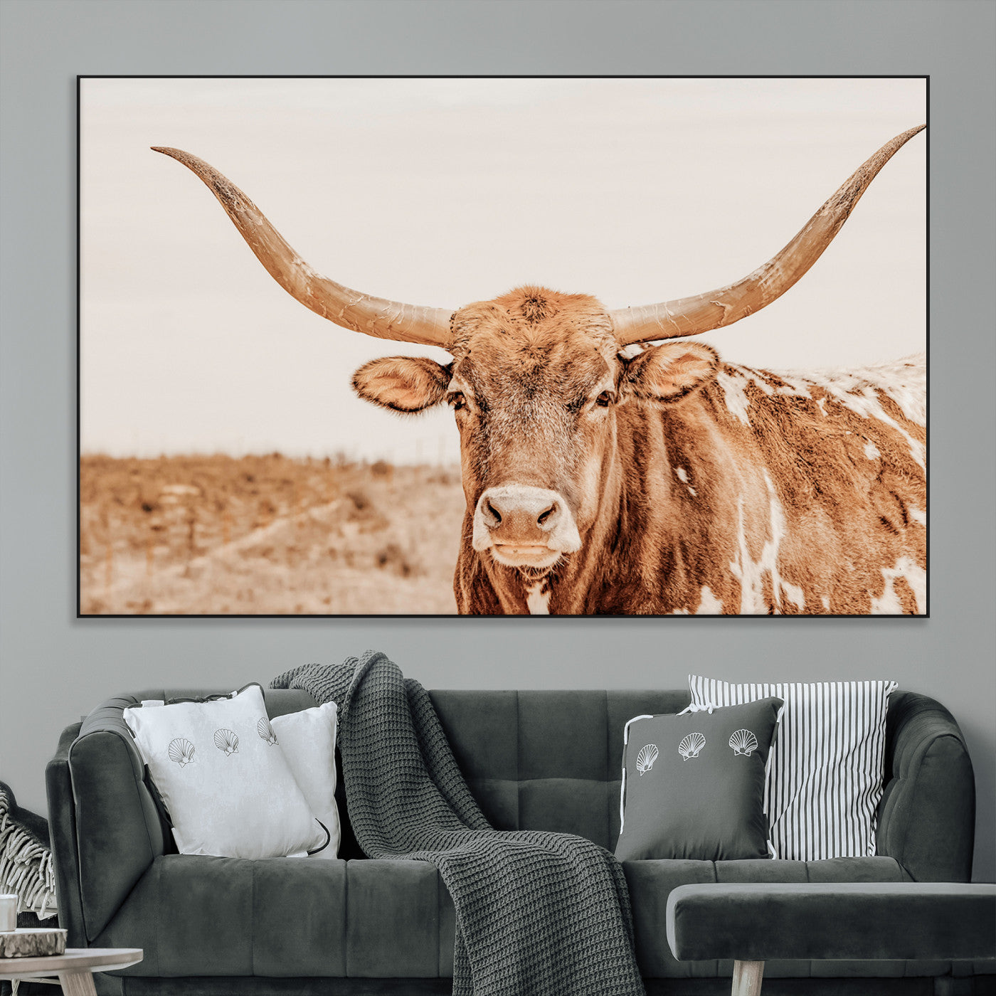 A longhorn bull standing proudly in a sunlit desert field with warm neutral tones, ideal for rustic western or farmhouse interiors.