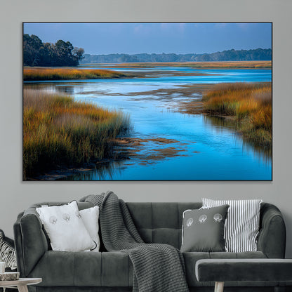 A peaceful marshland scene with calm blue water reflecting the surrounding grasses and trees, capturing the beauty of nature in a serene landscape.